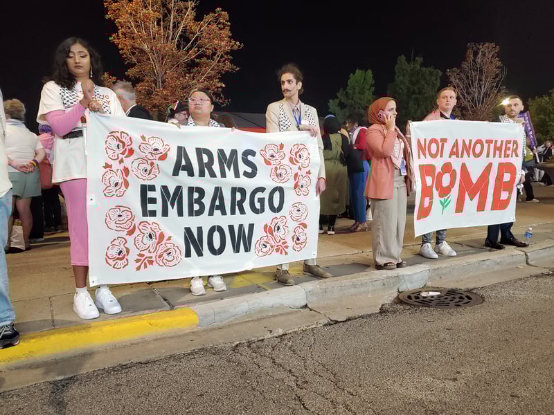 People hold signs reading "arms embargo now" and "not another bomb."