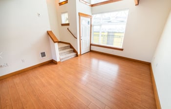 Bright living area in a Union Bay Lofts rental apartment, Seattle, with large windows and hardwood floors.