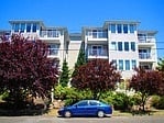 a blue car parked in front of a building