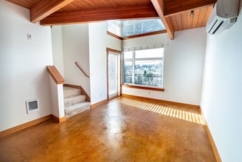 Union Bay Lofts Seattle apartment: bright living room with large windows, open floor plan, modern kitchen.