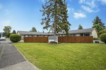 A building with a sign that says Cedar Lane in front of it.