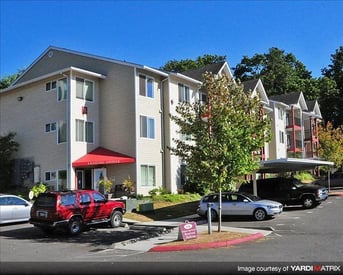 Bright living room at Chianti Apartments in Renton, WA, with modern decor and large windows.