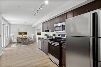 kitchen and dining room with stainless steel appliances and a table