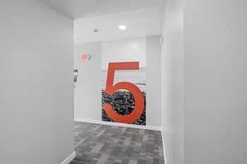 a room with a large red number 5 on the wall