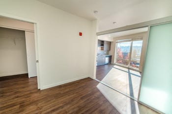Bright living room in a Vibe Apartments rental unit, Seattle, WA with modern furniture and large windows.