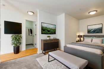 Bright living room at Gilbert House Apartments, Seattle, WA; spacious rental with large windows.