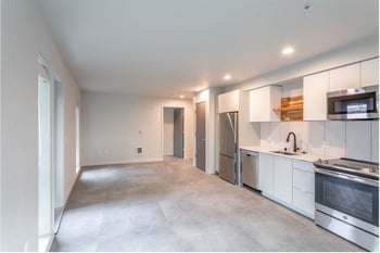 Robins Nest Seattle apartment: bright living room with large window, contemporary furnishings, and hardwood floors.