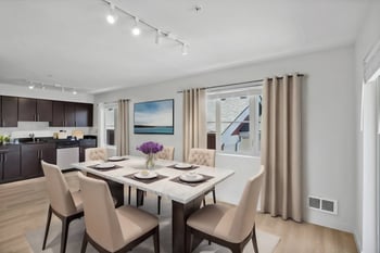 a dining room with a table and chairs