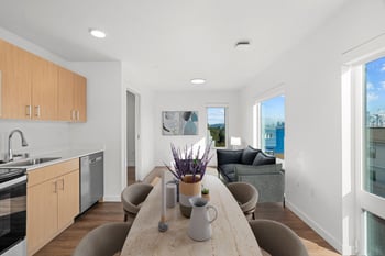 a kitchen and living room with a table and chairs