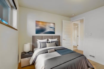 Bedroom with a bed, nightstand, and window.