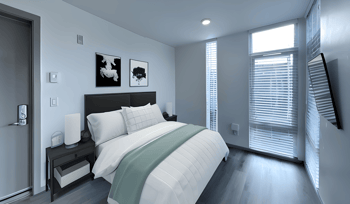 a bedroom with a bed and a window