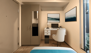 a hotel room with a bed and a desk with a laptop