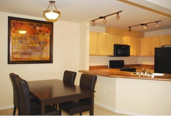 Bright living room at Chianti Apartments, Renton, WA, featuring large windows, contemporary furnishings, and soft lighting.