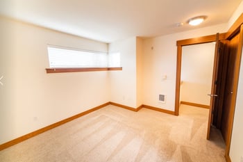 Studio apartment at Union Bay Lofts, Seattle, WA; bright living area with kitchen, island, and hardwood floors.