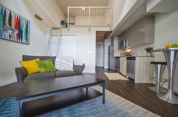 Larson Building apartment living room in Seattle, WA with a large window and modern decor.