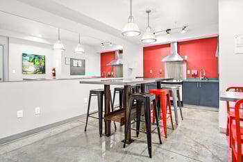 Bright apartment living room at Wallingford Studios, Seattle, WA, with modern furnishings and large window.