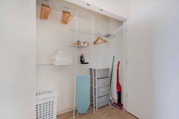 a closet with some clothes and shelves on it