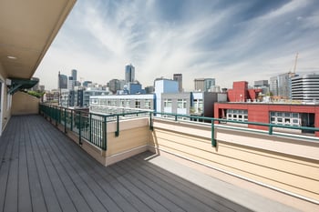 A balcony with a view of a city skyline.