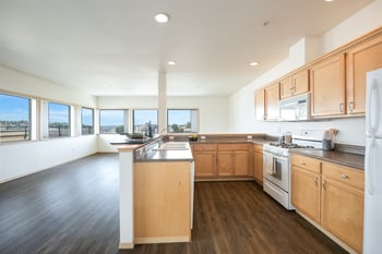 A kitchen with wooden cabinets and a white refrigerator.