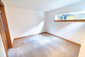 Union Bay Lofts Seattle apartment living room with large windows and hardwood floors.