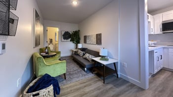 a living room with a couch and a chair and a table