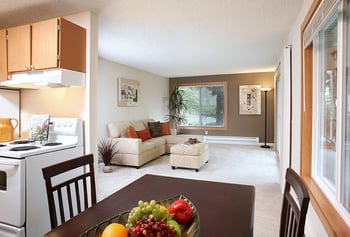 Bright living room in a Hill Crest Apartments unit, Tukwila, WA - modern rental interior with large windows.