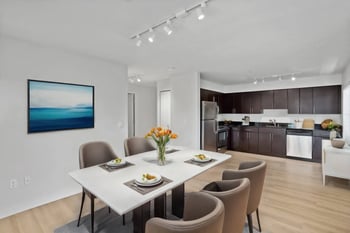 One-bedroom apartment at REV Fremont, Seattle, WA; sunny living room, modern kitchen, large window, ideal rental.
