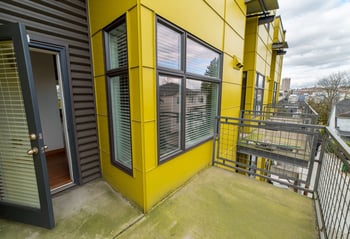 Bright living room at Union Bay Lofts, Seattle, WA; modern furnishings, large windows, rental unit.