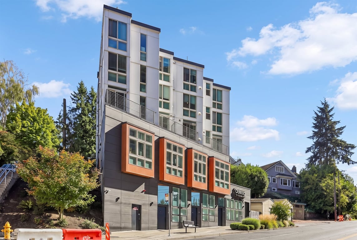 Modern terraced apartment building exterior with large windows and balconies at Odessa Apartments...