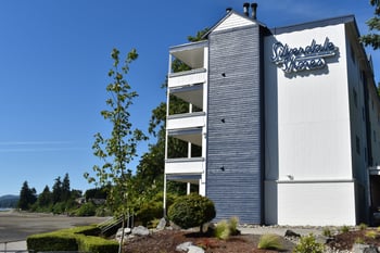 an apartment building with a sign on the side of it