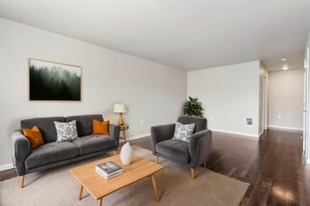 Ludwig Apartments, Seattle rental living room with bright decor and large windows.