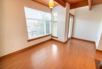 Union Bay Lofts apartment living area for rent, Seattle, WA — bright space with large windows.