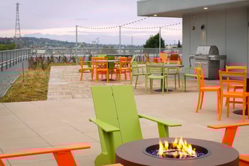 Studio interior at Vibe Apartments, Seattle, WA—open living area with modern kitchenette and large window.