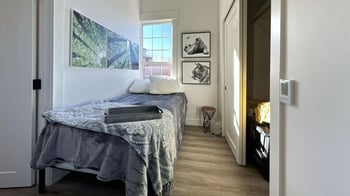 a bedroom with a bed and a window