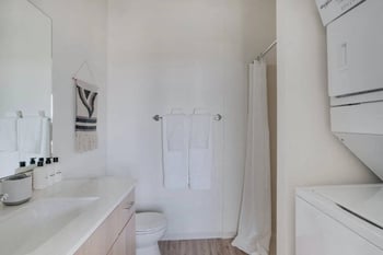 a bathroom with a sink and a toilet and a shower