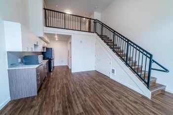 Lillehammer Apartments, Seattle WA: bright living room in rental unit with large windows and modern furnishings.