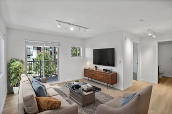 a living room with a couch and a television on the wall