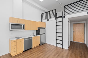 an empty room with white walls and a wood floor