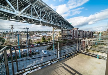 Union Bay Lofts rental: bright living area with floor-to-ceiling windows, Seattle, WA.
