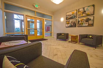 Bright Seattle Larson Building apartment living room with large windows and modern finishes.