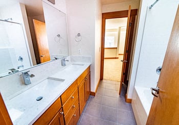 Bright living space at Union Bay Lofts, Seattle: open floor plan, hardwood floors, large windows, modern kitchen.