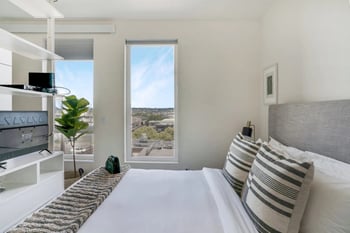 a bedroom with a bed and a window