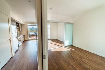 Bright Seattle apartment at Vibe Apartments featuring open living area, hardwood floors, and a modern kitchen.