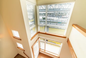 Interior view of Union Bay Lofts rental in Seattle, WA; bright living area with skyline view and modern finishes.