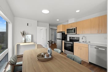 an open kitchen and dining room with a wooden table
