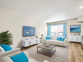 Bright living area in a Seattle apartment at 509 1st Ave, featuring large windows and a modern kitchen.