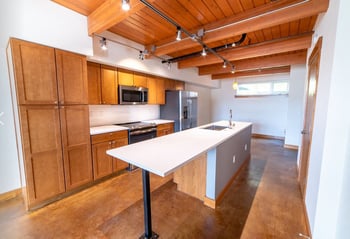 Union Bay Lofts apartment interior in Seattle, WA: bright living room with large windows and modern finishes.