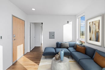 a living room with a blue couch and a coffee table