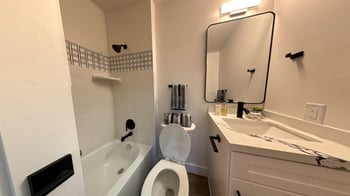 a small bathroom with a sink toilet and bath tub