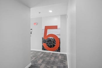 a room with a large red number 5 on the wall